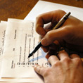 close up of hand filling in a voting form